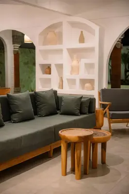 a living room with a couch and a table and chairs at Villa Batu Putih Seminyak in Seminyak