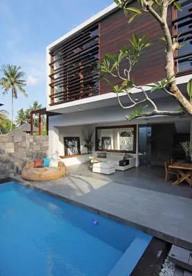 a house with a swimming pool next to a house at Abivilla in Seminyak