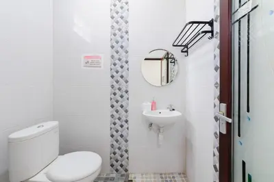 a bathroom with a toilet and a sink at RedDoorz at Lotus House Seminyak in Seminyak