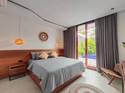 a bedroom with a bed and a large window at Cosy Haven 2 BR Villa in Umalas in Canggu