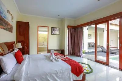 a bedroom with a large white bed and a balcony at 1 Bed Room Villa In Seminyak in Seminyak