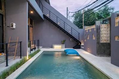 a swimming pool in the backyard of a house at Alaya Homes A - Luxury Japandi Loft Suite in Seminyak in Seminyak
