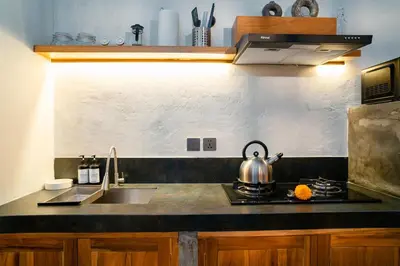 a kitchen counter with a sink and a tea kettle at Alaya Homes C - Elegant Japandi Loft Suite in Seminyak in Seminyak