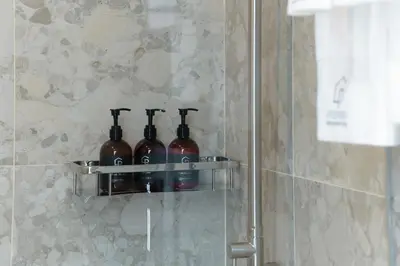a group of wine bottles sitting on a shelf in a bathroom at Premier Umalas Villas in Seminyak