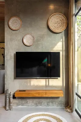 a flat screen tv on a wall with plates on it at 10 mins to beach - BRAND NEW 1 BD w/Pool + Netflix in Canggu