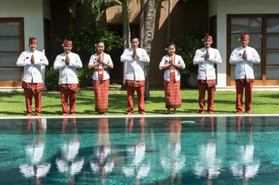 a group of men standing in front of a swimming pool at Villa Tiga Puluh, 7 Bedrooms Private Villa in Seminyak in Seminyak
