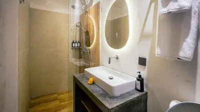 a bathroom with a sink and a shower at Alaya Homes B - Stylish Japandi Loft Suite in Seminyak in Seminyak