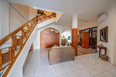 a living room with a staircase and a couch at Villa WES - Legian - 5 Bedroom - 4 Bath - Location in Seminyak