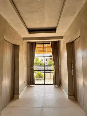 an empty hallway with a door leading to a balcony at Villa de Mer Bali in Legian