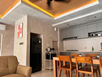 a kitchen with a table and chairs in a room at Villa de Mer Bali in Legian