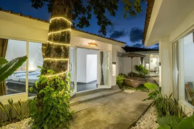 a house with a courtyard with a tree at LaLeBay Villa Seminyak in Seminyak