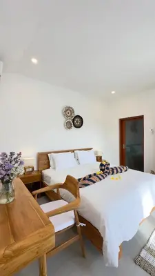 a bedroom with two beds and a table at 2 bedroom villa in Umalas in Kerobokan