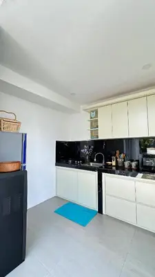 a kitchen with white cabinets and a blue rug at 2 bedroom villa in Umalas in Kerobokan