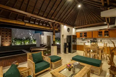 an open kitchen and living room with wooden furniture at 2 Bedroom Villa private Pool and BBQ Seminyak Bali in Seminyak