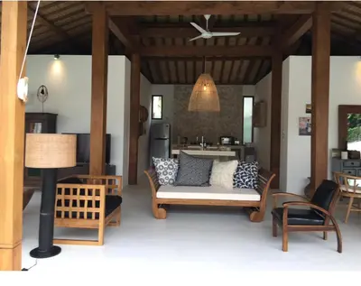 a living room with a couch and a kitchen at Milavila in Seminyak