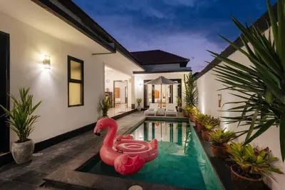 a pool with a pink swan in the middle of a house at Villa Sri, Seminyak - 3 Bedroom Stylish Pool Villa! in Seminyak