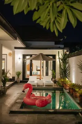 a pool with a red swan in the middle of a house at Villa Sri, Seminyak - 3 Bedroom Stylish Pool Villa! in Seminyak