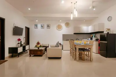 a kitchen and living room with a table and a counter at Villa Sri, Seminyak - 3 Bedroom Stylish Pool Villa! in Seminyak