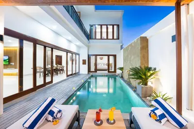 a swimming pool in a house with a villa at Villa Marili Seminyak by Nagisa Bali in Seminyak