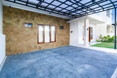 an empty garage with a stone wall at Villa Marili Seminyak by Nagisa Bali in Seminyak