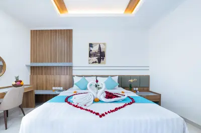 a bedroom with a bed with a heart made out of pillows at Villa Marili Seminyak by Nagisa Bali in Seminyak