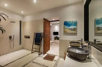 a bathroom with two sinks and a shower at Villa Kallayaan by Optimum Bali Villas in Seminyak