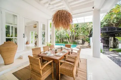 a dining room with a table and chairs at W villa in Seminyak