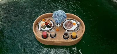 a small boat in the water with food on it at Alaya Homes D - Chic Japandi Loft Suite in Seminyak in Seminyak