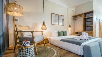 a bedroom with a bed and a chair in it at Alaya Homes D - Chic Japandi Loft Suite in Seminyak in Seminyak
