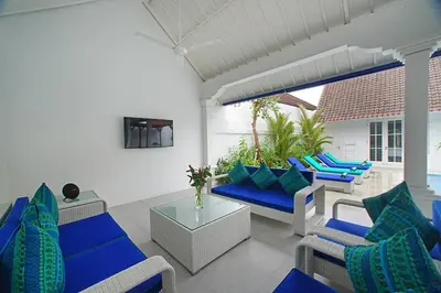 a patio with blue couches and blue pillows at Villa Ley Charming 2 Bedroom Villa Seminyak Private Pool in Seminyak