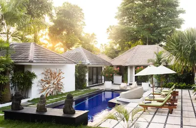 a villa with a swimming pool and a resort at Villa Arev in Kerobokan