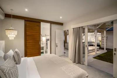 a bedroom with a white bed and a mirror at Villa Passion by Alfred in Bali in Seminyak