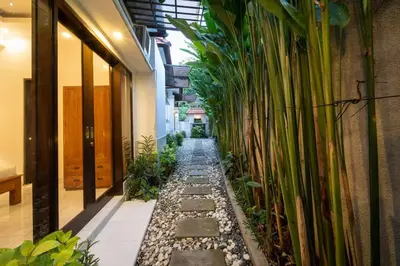 a hallway with plants on the side of a building at Villa Banua 3 Seminyak in Seminyak