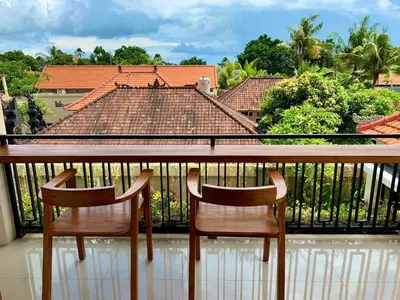 two chairs sitting at a table on a balcony at Villa Kumaru Luxury 4BR inc breakfast and airport pickup in Canggu