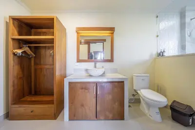 a bathroom with a toilet and a sink and a mirror at Villa Kumaru Luxury 4BR inc breakfast and airport pickup in Canggu