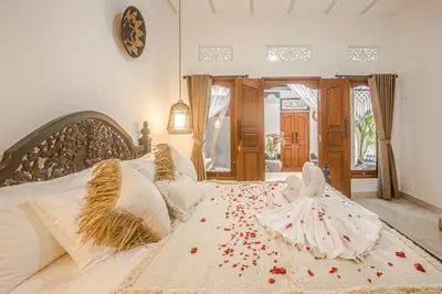 a bedroom with a bed with flowers on it at Villa Jasmine by JB VIllas in Seminyak