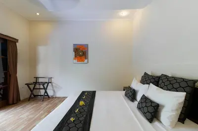 a bedroom with a white bed with pillows at Villa Tranquil Holiday Villa in Seminyak