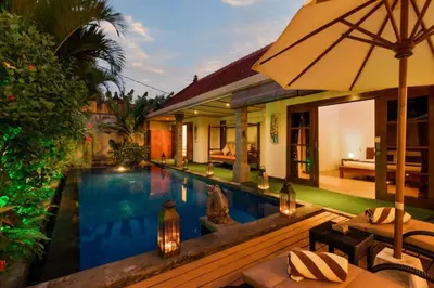a villa with a swimming pool and a resort at Villa Tranquil Holiday Villa in Seminyak