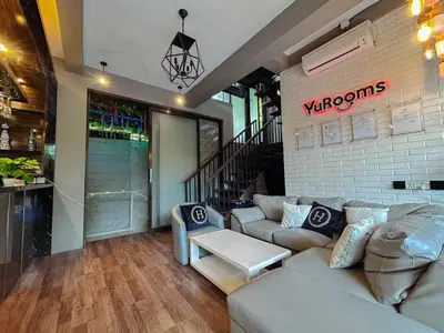 a living room with a couch and a table at YuRooms Villapartment - Love Room Bali in Jimbaran