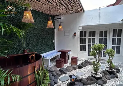 a patio with potted plants in front of a house at YuRooms Villapartment - Love Room Bali in Jimbaran