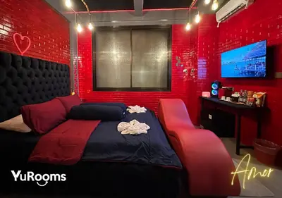 a red bedroom with a bed and a red wall at YuRooms Villapartment - Love Room Bali in Jimbaran