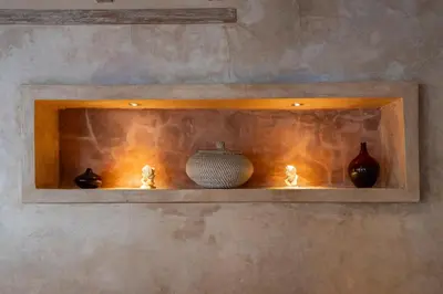 a shelf with vases and vases on it at Villa Amsa by Pertama Management in Seminyak