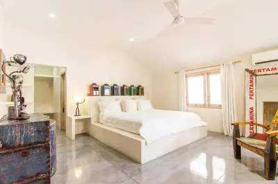 a white bedroom with a bed and a mirror at Luxurious&Spacious 4Br Villa in Seminyak in Seminyak