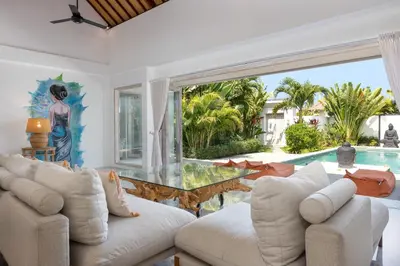 a living room with a glass table and a pool at Wonderful 4Br Villa in Seminyak in Seminyak