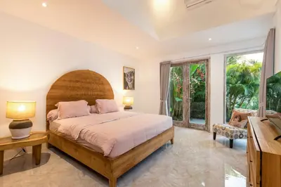 a bedroom with a bed and a large window at Wonderful 4Br Villa in Seminyak in Seminyak
