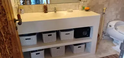 a bathroom with a sink with baskets under it at Balinese Luxury in The Centre of Seminyak in Legian