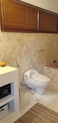 a bathroom with a white toilet in a room at Balinese Luxury in The Centre of Seminyak in Legian