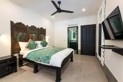 a bedroom with a bed and a ceiling fan at Villa Baruna Seminyak in Seminyak