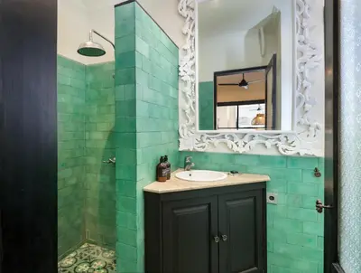 a bathroom with a sink and a mirror at Villa Baruna Seminyak in Seminyak