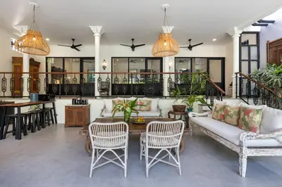a living room with a couch and chairs and a table at Villa Baruna Seminyak in Seminyak